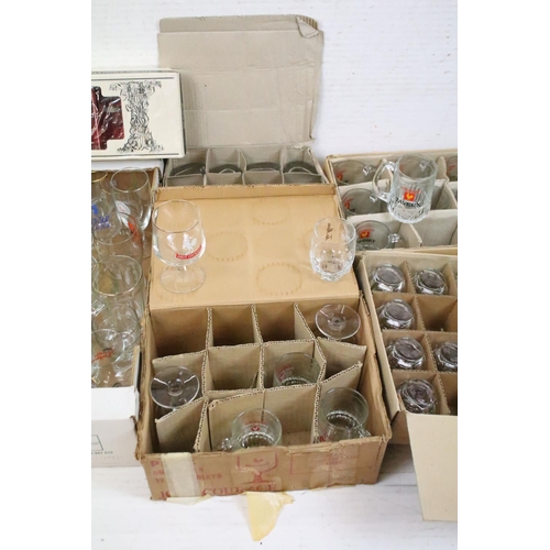 385 - A large collection of drinking glasses to include advertising examples contained within seven boxes.