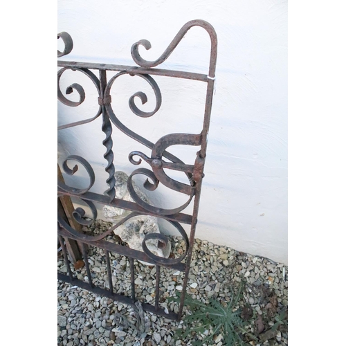 557 - Wrought iron garden gate of scrolled design, measures approx 100cm wide; together with a wooden ladd... 