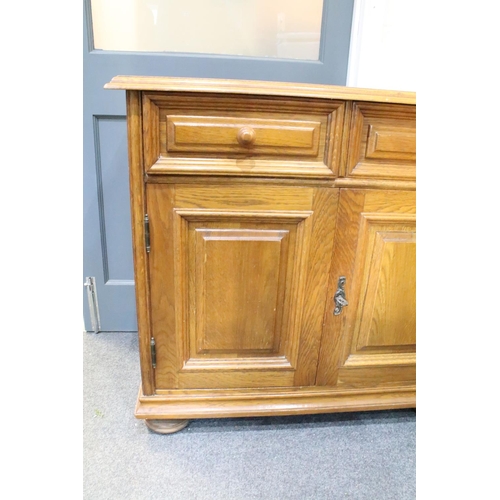 571 - German Oak Dresser Base or Side Cabinet with two drawers over two cupboard doors, raised on bun feet... 