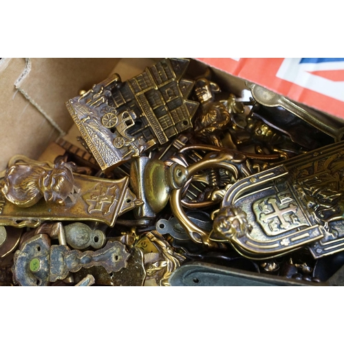 292 - A large collection of brass and copper door knockers to include novelty examples.