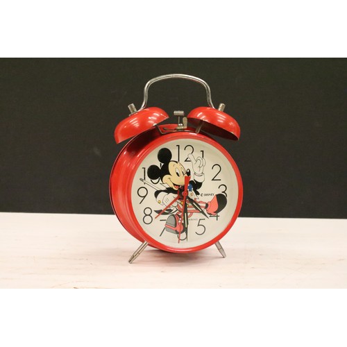 401A - A collection of three vintage wind up alarm clocks to include Micky Mouse and Aladin examples.