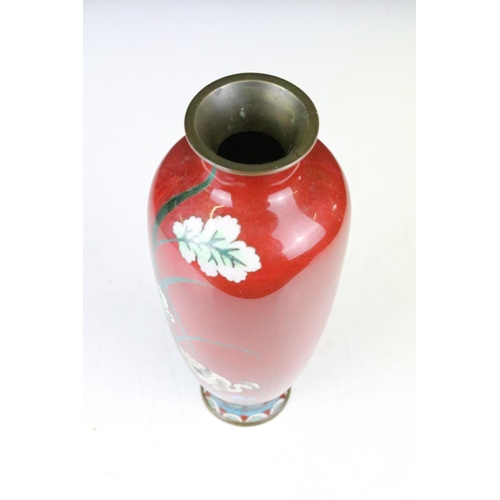 122 - Japanese Cloisonné Vase decorated with a stork amongst flowers on a red ground, 25cm high