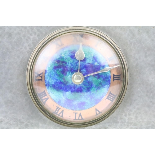 131 - Liberty & Co. pewter mantel clock, the rectangular beaten case with a circular blue enamel & copper ... 