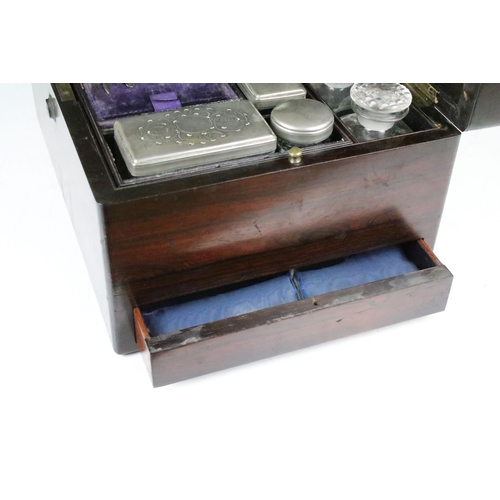 144 - 19th Century rosewood travelling vanity box, the lid opening to a fitted interior housing glass bott... 