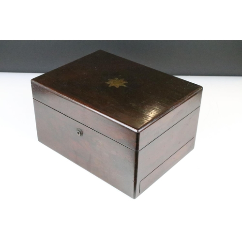 144 - 19th Century rosewood travelling vanity box, the lid opening to a fitted interior housing glass bott... 