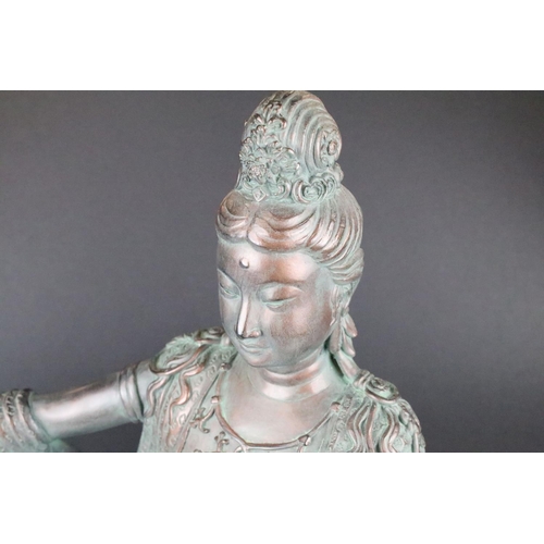 150 - Bronze effect figure of a seated Buddhist female deity, with orb in hand, approx 51cm tall