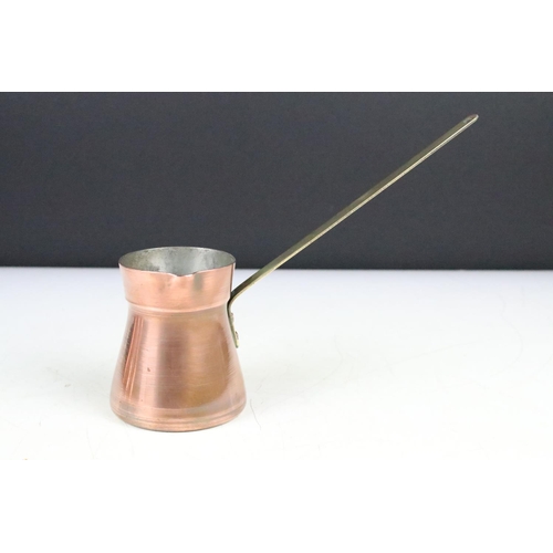 177 - Set of Four Copper Pouring Measure Jugs with brass handles, the largest 17cm (to top of handle)