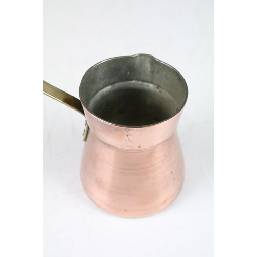 177 - Set of Four Copper Pouring Measure Jugs with brass handles, the largest 17cm (to top of handle)