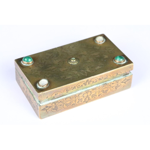 190 - An antique brass vesta box with chased decoration and cabochon settings to lid, strkier to base and ... 