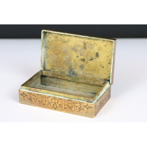 190 - An antique brass vesta box with chased decoration and cabochon settings to lid, strkier to base and ... 