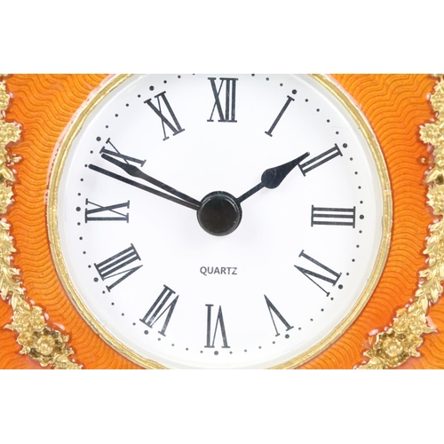 195 - Ornate Gilt Metal and Orange Enamelled Table Clock, 12cm high