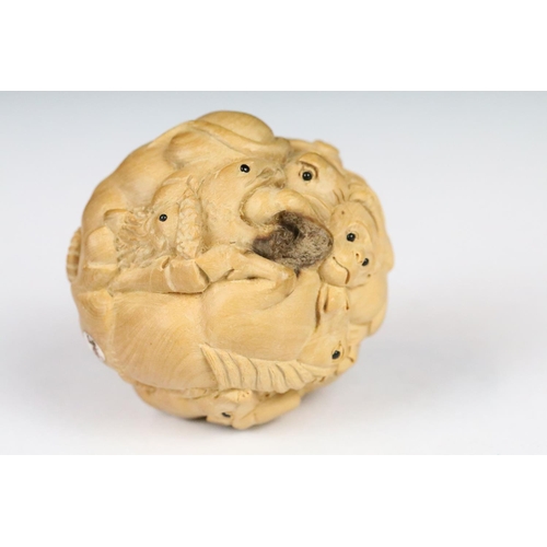 199 - An oriental boxwood spherical carving of animals to include rats, horse, ram, monkey...etc.. signed ... 