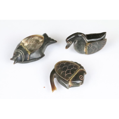 200 - A collection of three carved horn snuff boxes in the form of animals to include two fish and a bird.