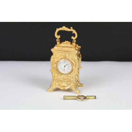 254 - Miniature Carriage Clock in a Rococo style case with key