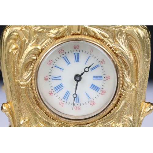 254 - Miniature Carriage Clock in a Rococo style case with key