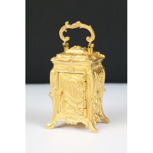 254 - Miniature Carriage Clock in a Rococo style case with key