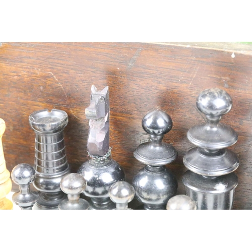 267 - A turned wooden chess set within an antique wooden box, queen stands approx 9cm in height.