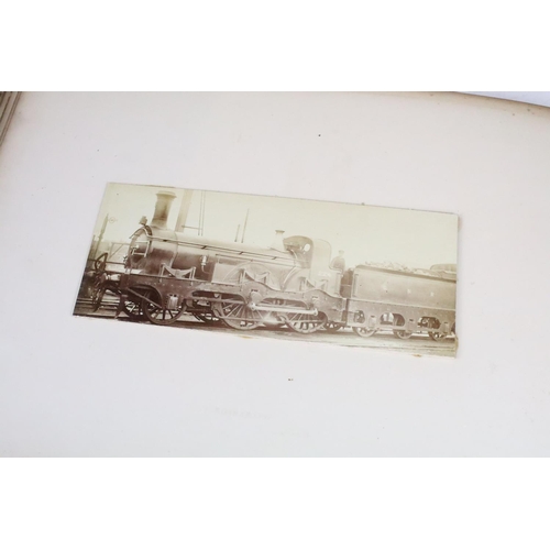 410 - An early 20th century photograph album containing black & white photographs of steam trains.