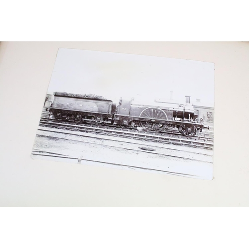 410 - An early 20th century photograph album containing black & white photographs of steam trains.