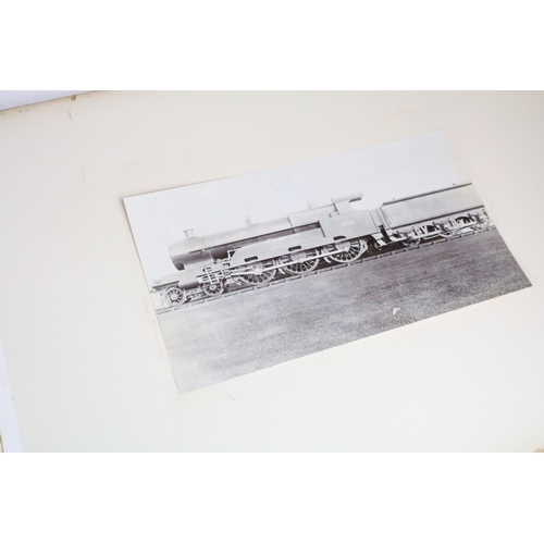 410 - An early 20th century photograph album containing black & white photographs of steam trains.