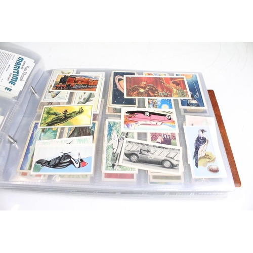 411 - A large collection of cigarette cards contained within four albums to include Players, Black Cat and... 