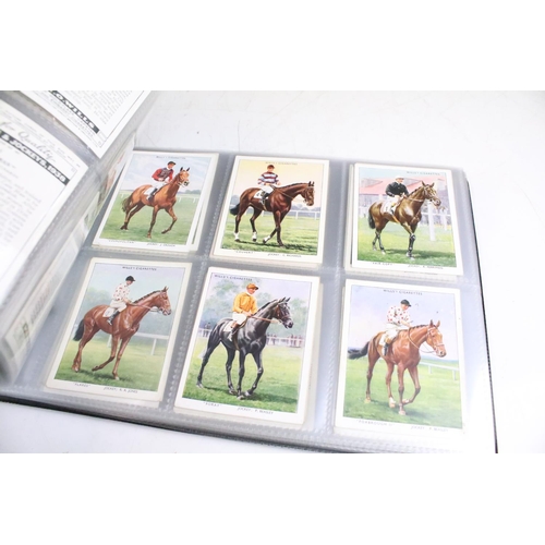 411 - A large collection of cigarette cards contained within four albums to include Players, Black Cat and... 