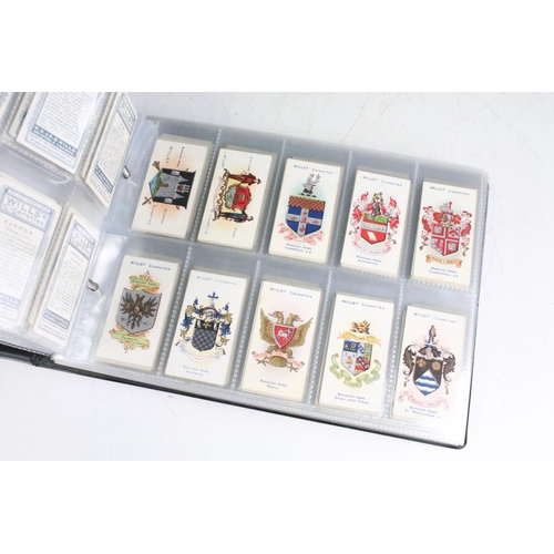 414 - A large collection of cigarette cards within six albums to include Wills, Players, Black Cat, Chings... 