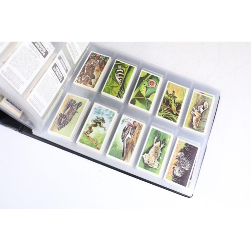 414 - A large collection of cigarette cards within six albums to include Wills, Players, Black Cat, Chings... 