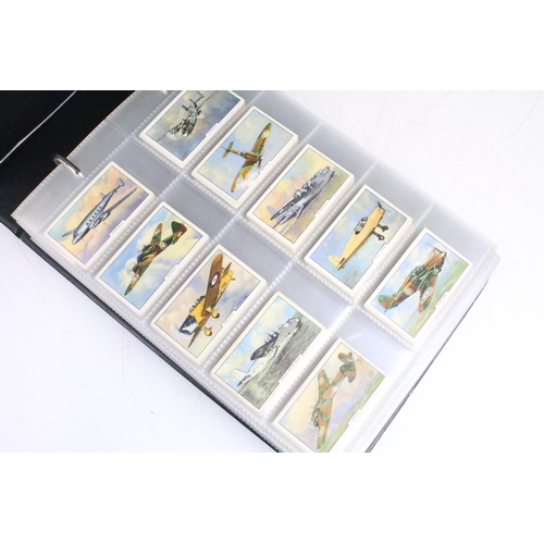 414 - A large collection of cigarette cards within six albums to include Wills, Players, Black Cat, Chings... 