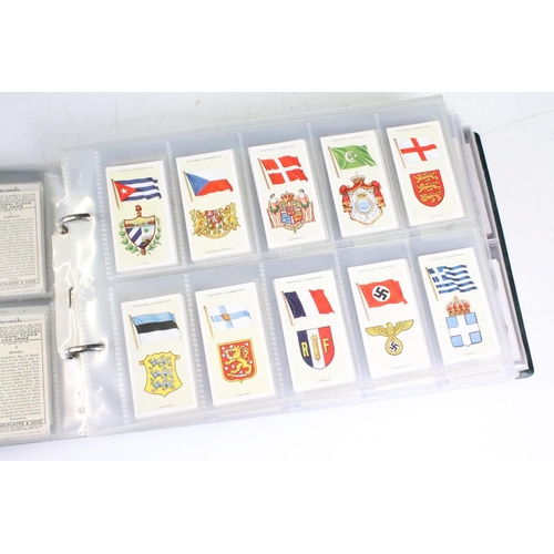 415 - A collection of cigarette cards contained within albums to include Players, Black Cat and Gallaher e... 