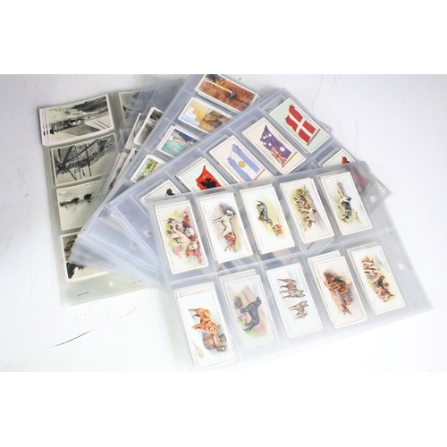 415 - A collection of cigarette cards contained within albums to include Players, Black Cat and Gallaher e... 