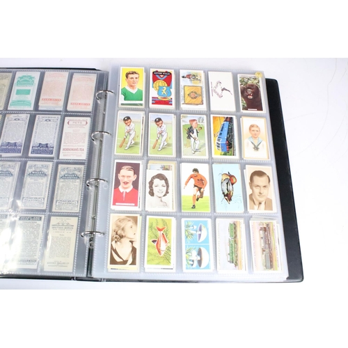 415 - A collection of cigarette cards contained within albums to include Players, Black Cat and Gallaher e... 