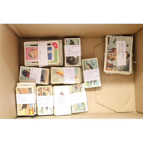 425 - A box of mixed collectables to include cigarette cards, 1960's / 1970's button badges to include The... 