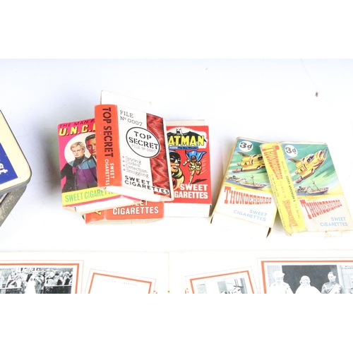 425 - A box of mixed collectables to include cigarette cards, 1960's / 1970's button badges to include The... 