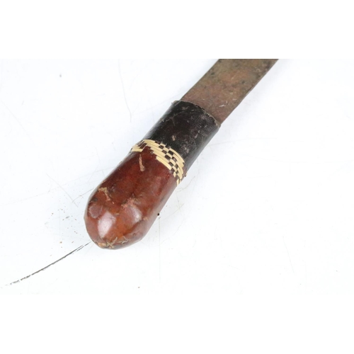 285 - A vintage Kenyan Maasai warriors knife together with a small example.