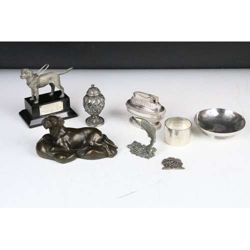 287 - A box of mixed collectables to include a hallmarked silver napkin ring, table lighter, dog ornament,... 