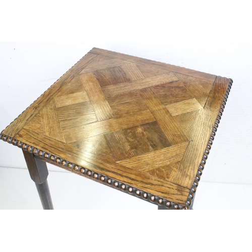 628 - Arts and Crafts Oak Square Table with parquet top and beaded edge raised on turned tapering legs, 73... 