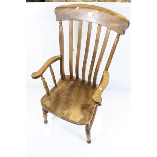 630 - Farmhouse Lathe Back Elm Seated Windsor Elbow Chair, 106cm high x 60cm wide together with Ercol Elbo... 