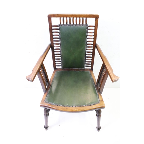 558 - Arts and Crafts style Spindle Back Elbow Chair with studded green leather back and seat raised on tu... 