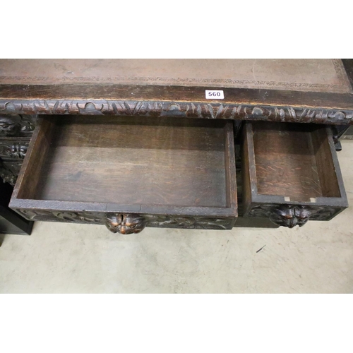 560 - Victorian Carved Dark Oak Desk with brown leather inset top over an arrangement of nine heavily carv... 