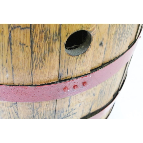 582 - Large Coopered Golden Oak Barrel or Cask, the metal bands painted red, 86cm high x 59cm diameter