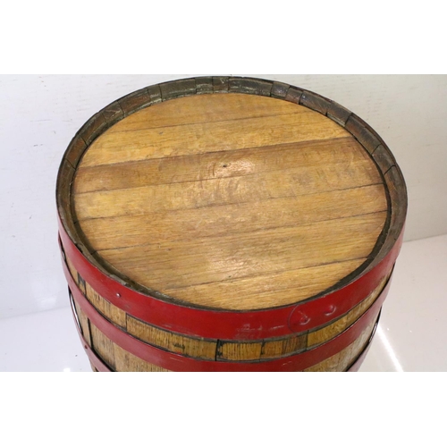 582 - Large Coopered Golden Oak Barrel or Cask, the metal bands painted red, 86cm high x 59cm diameter