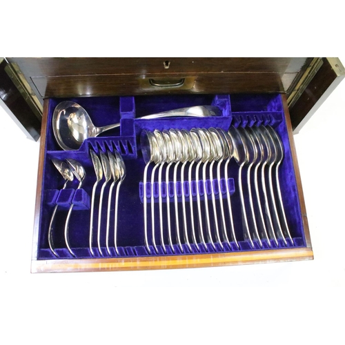 299 - A two drawer canteen of silver plated cutlery together with a hallmarked sterling silver hand mirror... 