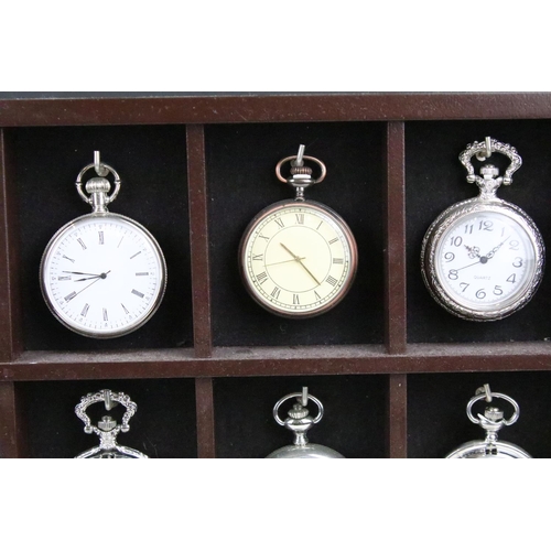 300 - A collection of fifteen contemporary pocket watches contained within a wooden wall mounted display c... 