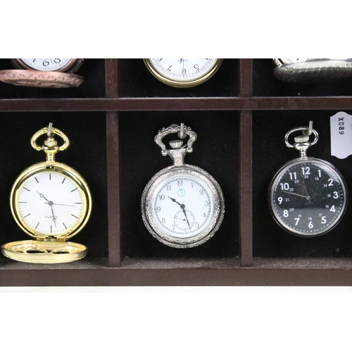 300 - A collection of fifteen contemporary pocket watches contained within a wooden wall mounted display c... 