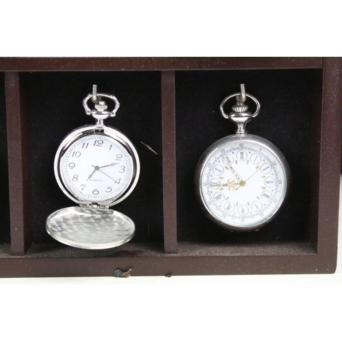 300 - A collection of fifteen contemporary pocket watches contained within a wooden wall mounted display c... 