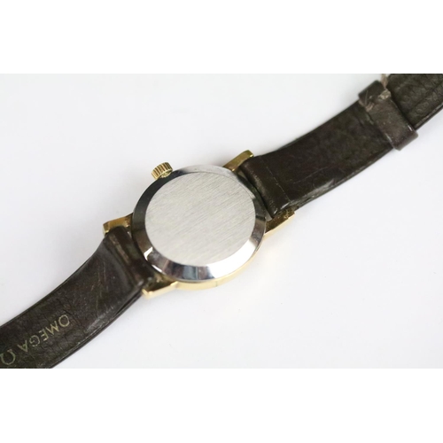 313 - A ladies Omega Geneve wristwatch, gold dial with baton markers on original strap..