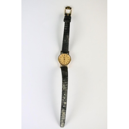 314 - A ladies Omega quartz wristwatch, gold dial with baton markers on original strap..