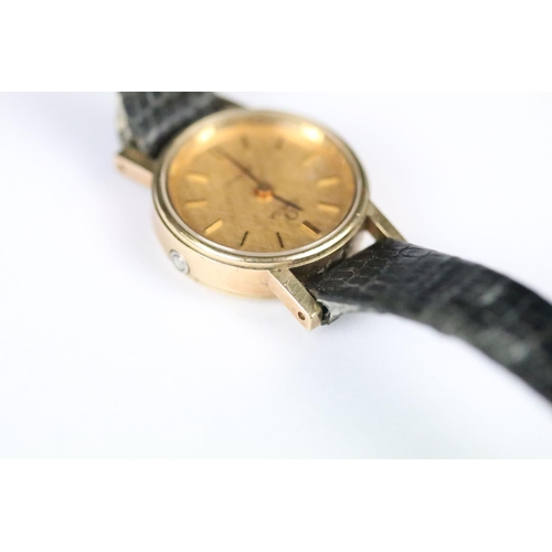 314 - A ladies Omega quartz wristwatch, gold dial with baton markers on original strap..