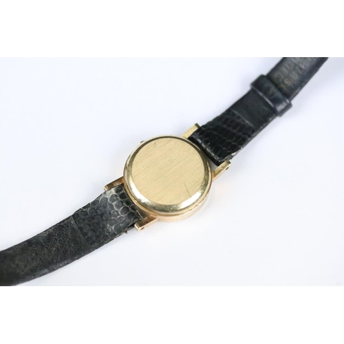 314 - A ladies Omega quartz wristwatch, gold dial with baton markers on original strap..